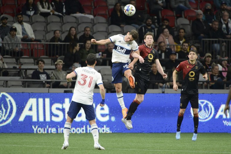May 11, 2022; Vancouver, British Columbia, Canada;  Vancouver Whitecaps midfielder Sebastian Berhalter (16) goes up for a header against Valour FC forward Daryl Fordyce (16) during the second half at BC Place. Mandatory Credit: Anne-Marie Sorvin-USA TODAY Sports