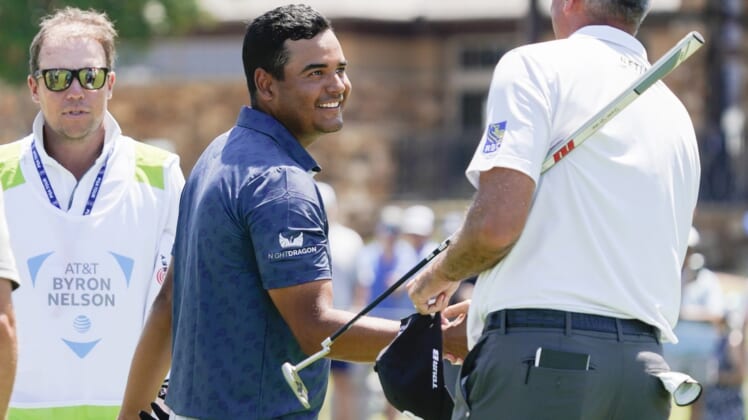 May 12, 2022; McKinney, Texas, USA; Sebastian Munoz shakes the hand of playing partner Matt Kuchar on the 18th green after completing his 12-under round of 60 during the first round of the AT&T Byron Nelson golf tournament. Mandatory Credit: Raymond Carlin III-USA TODAY Sports