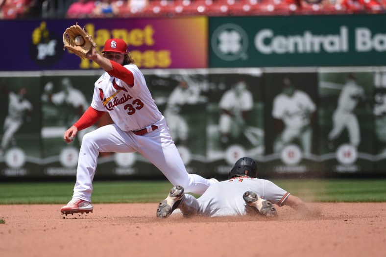 May 12, 2022; St. Louis, Missouri, USA; Baltimore Orioles second baseman Chris Owings (11) steals second base ahead of the throw to St. Louis Cardinals shortstop Brendan Donovan (33) at Busch Stadium. Mandatory Credit: Joe Puetz-USA TODAY Sports