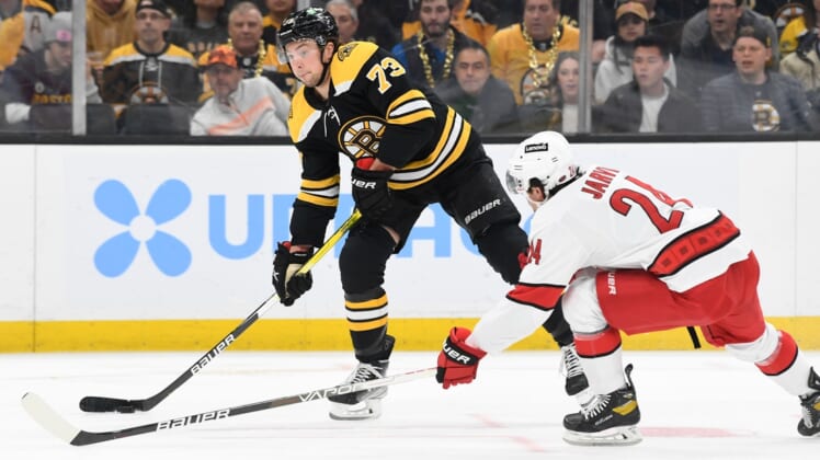 May 12, 2022; Boston, Massachusetts, USA; Boston Bruins defenseman Charlie McAvoy (73) looks to shoot the puck in front of Carolina Hurricanes center Seth Jarvis (24) during the first period at the TD Garden. Mandatory Credit: Brian Fluharty-USA TODAY Sports