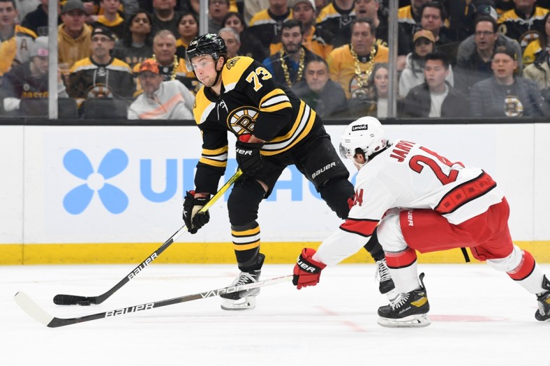 May 12, 2022; Boston, Massachusetts, USA; Boston Bruins defenseman Charlie McAvoy (73) looks to shoot the puck in front of Carolina Hurricanes center Seth Jarvis (24) during the first period at the TD Garden. Mandatory Credit: Brian Fluharty-USA TODAY Sports