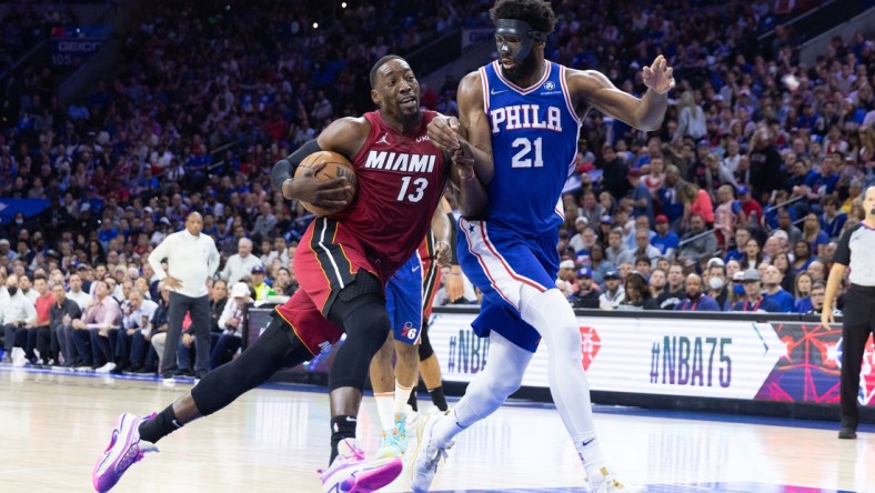 May 12, 2022; Philadelphia, Pennsylvania, USA; Miami Heat center Bam Adebayo (13) drives against Philadelphia 76ers center Joel Embiid (21) during the first quarter in game six of the second round of the 2022 NBA playoffs at Wells Fargo Center. Mandatory Credit: Bill Streicher-USA TODAY Sports