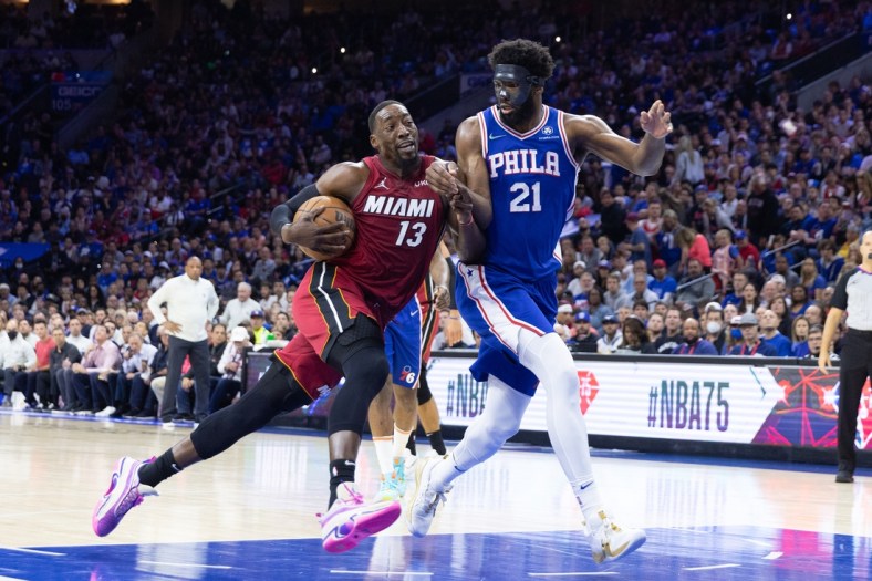 May 12, 2022; Philadelphia, Pennsylvania, USA; Miami Heat center Bam Adebayo (13) drives against Philadelphia 76ers center Joel Embiid (21) during the first quarter in game six of the second round of the 2022 NBA playoffs at Wells Fargo Center. Mandatory Credit: Bill Streicher-USA TODAY Sports