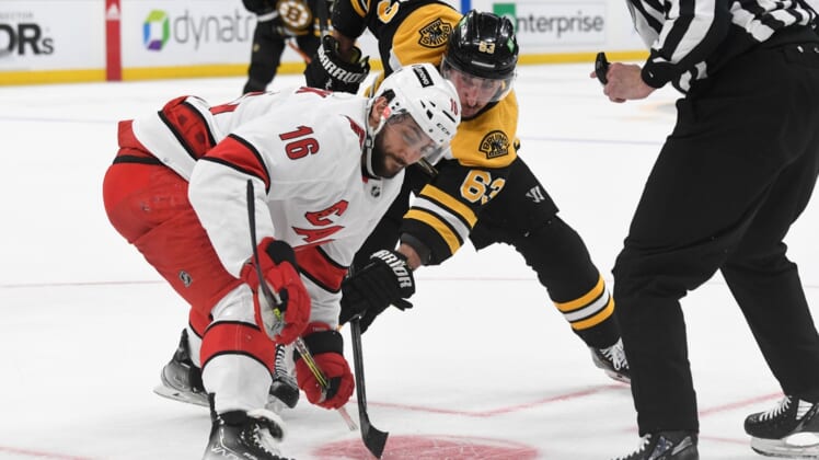 May 12, 2022; Boston, Massachusetts, USA; Boston Bruins left wing Brad Marchand (63) and Carolina Hurricanes center Vincent Trocheck (16) at a face-off during the third period at the TD Garden. Mandatory Credit: Brian Fluharty-USA TODAY Sports
