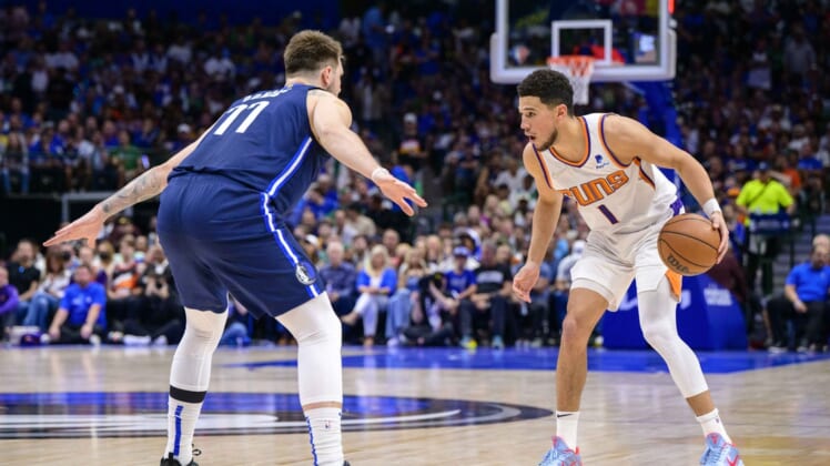 May 12, 2022; Dallas, Texas, USA; Dallas Mavericks guard Luka Doncic (77) guards Phoenix Suns guard Devin Booker (1) during the first quarter during game six of the second round of the 2022 NBA playoffs at the American Airlines Center. Mandatory Credit: Jerome Miron-USA TODAY Sports