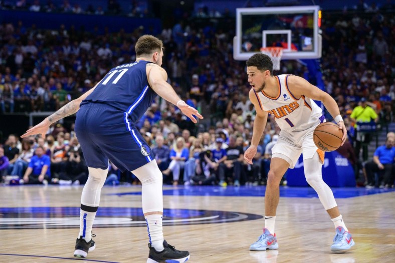 May 12, 2022; Dallas, Texas, USA; Dallas Mavericks guard Luka Doncic (77) guards Phoenix Suns guard Devin Booker (1) during the first quarter during game six of the second round of the 2022 NBA playoffs at the American Airlines Center. Mandatory Credit: Jerome Miron-USA TODAY Sports