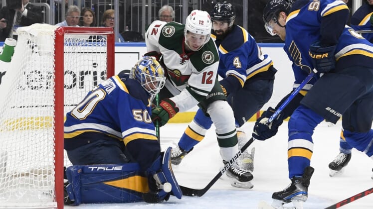 May 12, 2022; St. Louis, Missouri, USA; St. Louis Blues goaltender Jordan Binnington (50) makes a save on Minnesota Wild left wing Matt Boldy (12) during the first period in game six of the first round of the 2022 Stanley Cup Playoffs at Enterprise Center. Mandatory Credit: Jeff Le-USA TODAY Sports