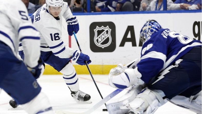 May 12, 2022; Tampa, Florida, USA; Toronto Maple Leafs right wing Mitchell Marner (16) skates with the puck as Tampa Bay Lightning goaltender Andrei Vasilevskiy (88) defends during overtime of game six of the first round of the 2022 Stanley Cup Playoffs at Amalie Arena. Mandatory Credit: Kim Klement-USA TODAY Sports