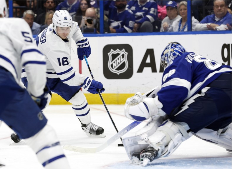 May 12, 2022; Tampa, Florida, USA; Toronto Maple Leafs right wing Mitchell Marner (16) skates with the puck as Tampa Bay Lightning goaltender Andrei Vasilevskiy (88) defends during overtime of game six of the first round of the 2022 Stanley Cup Playoffs at Amalie Arena. Mandatory Credit: Kim Klement-USA TODAY Sports