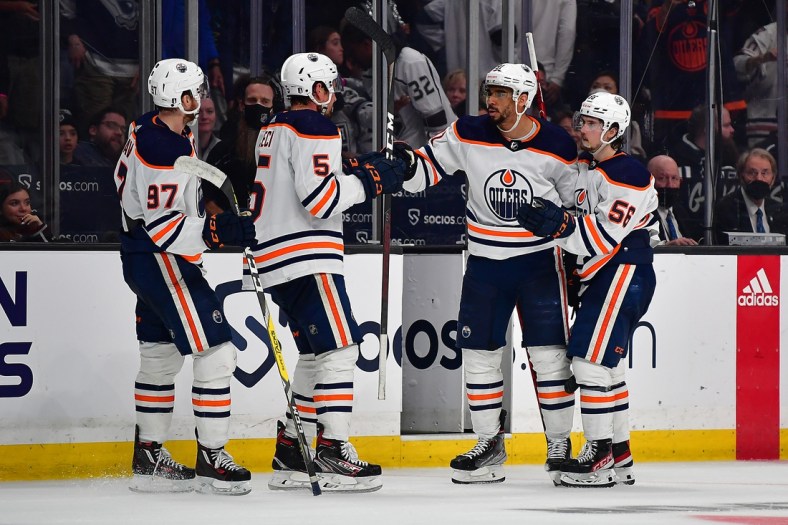 May 12, 2022; Los Angeles, California, USA; Edmonton Oilers left wing Evander Kane (91) celebrates with center Connor McDavid (97) defenseman Cody Ceci (5) and right wing Kailer Yamamoto (56) his empty net goal scored against the Los Angeles Kings during the third period in game six of the first round of the 2022 Stanley Cup Playoffs at Crypto.com Arena. Mandatory Credit: Gary A. Vasquez-USA TODAY Sports