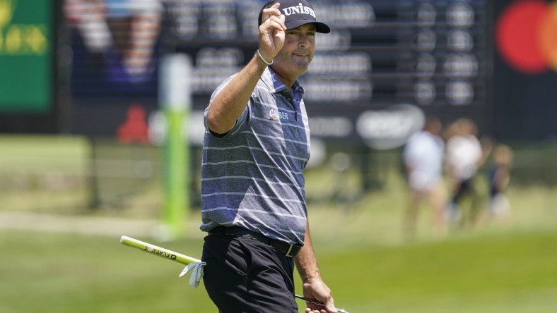 May 13, 2022; McKinney, Texas, USA; Ryan Palmer waves to the gallery as he walks off the ninth green after shooting a 10-under 62 during the second round of the AT&T Byron Nelson golf tournament. Mandatory Credit: Raymond Carlin III-USA TODAY Sports