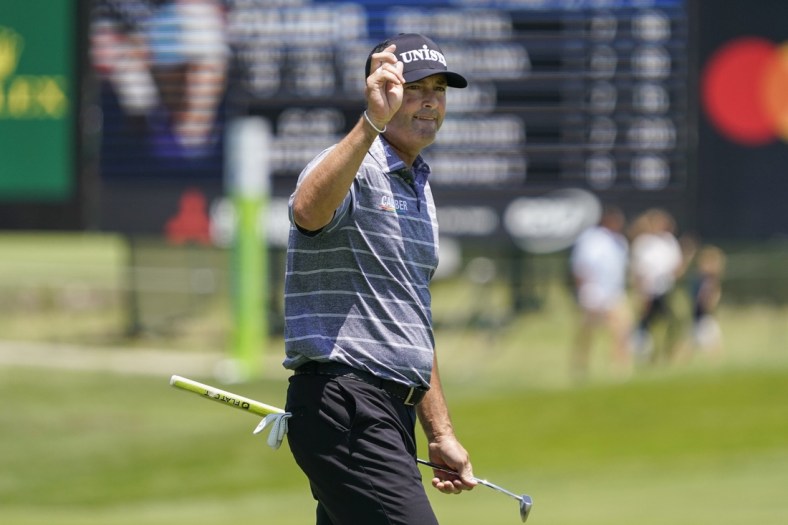 May 13, 2022; McKinney, Texas, USA; Ryan Palmer waves to the gallery as he walks off the ninth green after shooting a 10-under 62 during the second round of the AT&T Byron Nelson golf tournament. Mandatory Credit: Raymond Carlin III-USA TODAY Sports