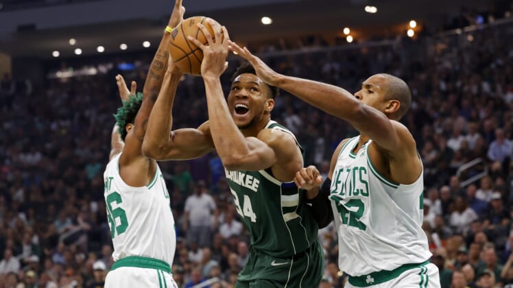 May 13, 2022; Milwaukee, Wisconsin, USA;  Milwaukee Bucks forward Giannis Antetokounmpo (34) drives for the basket between Boston Celtics guard Marcus Smart (36) and forward Al Horford (42) during the first quarter during game six of the second round for the 2022 NBA playoffs at Fiserv Forum. Mandatory Credit: Jeff Hanisch-USA TODAY Sports