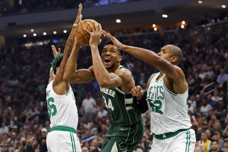 May 13, 2022; Milwaukee, Wisconsin, USA;  Milwaukee Bucks forward Giannis Antetokounmpo (34) drives for the basket between Boston Celtics guard Marcus Smart (36) and forward Al Horford (42) during the first quarter during game six of the second round for the 2022 NBA playoffs at Fiserv Forum. Mandatory Credit: Jeff Hanisch-USA TODAY Sports