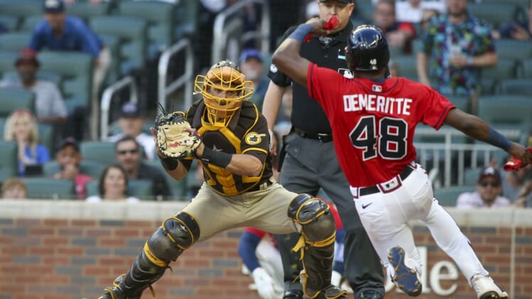 May 13, 2022; Atlanta, Georgia, USA; San Diego Padres catcher Austin Nola (26) tags out Atlanta Braves right fielder Travis Demeritte (48) at the plate in the first inning at Truist Park. Mandatory Credit: Brett Davis-USA TODAY Sports