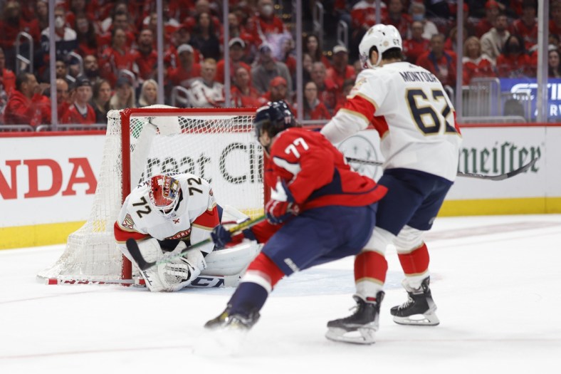 May 13, 2022; Washington, District of Columbia, USA; Florida Panthers goaltender Sergei Bobrovsky (72) covers the puck in front of Washington Capitals right wing T.J. Oshie (77) and Panthers defenseman Brandon Montour (62) in the first period in game six of the first round of the 2022 Stanley Cup Playoffs at Capital One Arena. Mandatory Credit: Geoff Burke-USA TODAY Sports