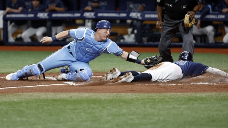 May 13, 2022; St. Petersburg, Florida, USA; Tampa Bay Rays second baseman Brandon Lowe (8) slides into home plate safe as Toronto Blue Jays catcher Tyler Heineman (22) attempted to tag him out during the second inning at Tropicana Field. Mandatory Credit: Kim Klement-USA TODAY Sports