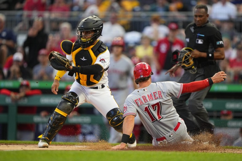 May 13, 2022; Pittsburgh, Pennsylvania, USA; Cincinnati Red shortstop Kyle Farmer (17) scores a run on Cincinnati Red right fielder TJ Friedl (29) (not pictured) sacrifice fly ball during the third inning against the Pittsburgh Pirates  at PNC Park. Mandatory Credit: Gregory Fisher-USA TODAY Sports