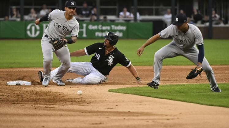 May 13, 2022; Chicago, Illinois, USA;  Chicago White Sox first baseman Jose Abreu (79) slides safely into second base after New York Yankees shortstop Isiah Kiner-Falefa (12, right) missed the play on the ball as New York Yankees second baseman Gleyber Torres (25) looks on during the first inning at Guaranteed Rate Field. Mandatory Credit: Matt Marton-USA TODAY Sports