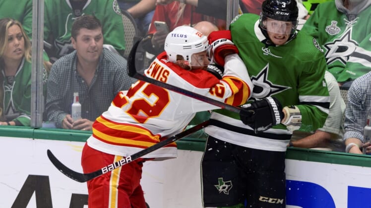 May 13, 2022; Dallas, Texas, USA; Calgary Flames center Trevor Lewis (22) checks Dallas Stars defenseman John Klingberg (3) during the first period in game six of the first round of the 2022 Stanley Cup Playoffs at American Airlines Center. Mandatory Credit: Jerome Miron-USA TODAY Sports