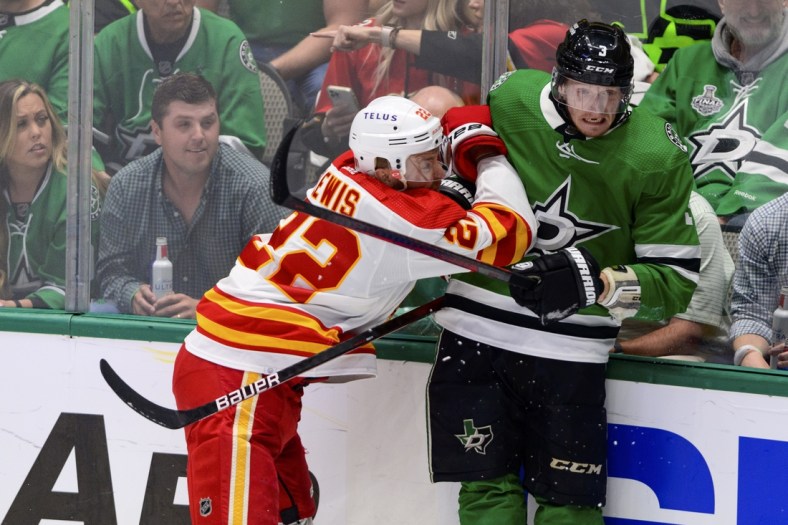 May 13, 2022; Dallas, Texas, USA; Calgary Flames center Trevor Lewis (22) checks Dallas Stars defenseman John Klingberg (3) during the first period in game six of the first round of the 2022 Stanley Cup Playoffs at American Airlines Center. Mandatory Credit: Jerome Miron-USA TODAY Sports