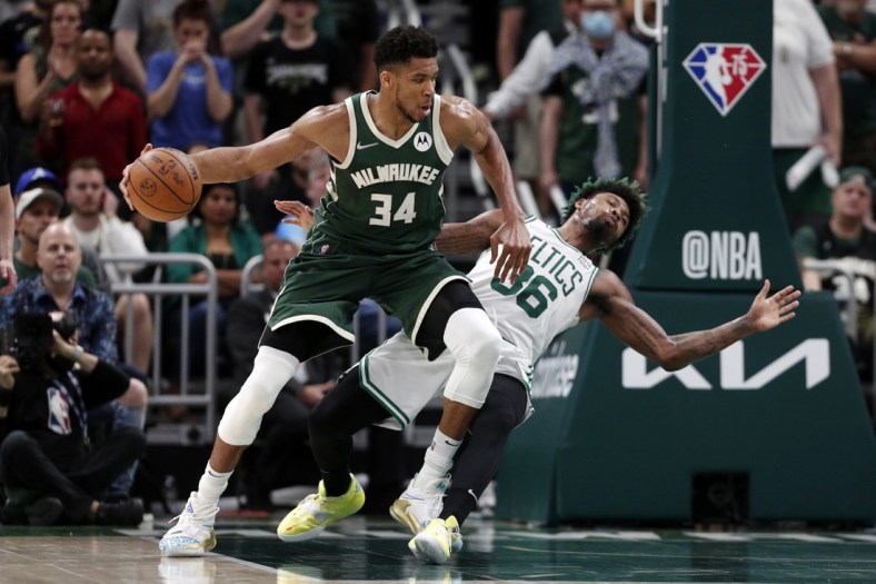 May 13, 2022; Milwaukee, Wisconsin, USA;  Boston Celtics guard Marcus Smart (36) falls away from Milwaukee Bucks forward Giannis Antetokounmpo (34) during the fourth quarter during game six of the second round for the 2022 NBA playoffs at Fiserv Forum. Mandatory Credit: Jeff Hanisch-USA TODAY Sports