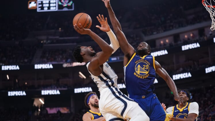 May 13, 2022; San Francisco, California, USA; Memphis Grizzlies forward Jaren Jackson Jr. (13) makes a shot next to Golden State Warriors forward Draymond Green (23) in the second quarter during game six of the second round for the 2022 NBA playoffs at Chase Center. Mandatory Credit: Cary Edmondson-USA TODAY Sports