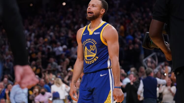 May 13, 2022; San Francisco, California, USA; Golden State Warriors guard Stephen Curry (30) walks towards the team bench after making a three point basket against the Memphis Grizzlies in the fourth quarter during game six of the second round for the 2022 NBA playoffs at Chase Center. Mandatory Credit: Cary Edmondson-USA TODAY Sports