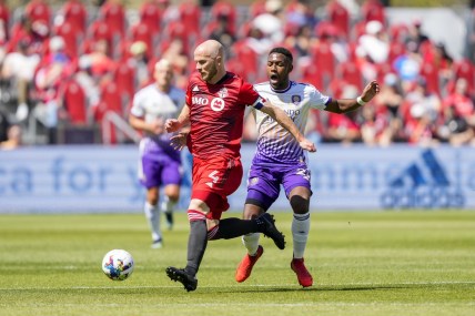 May 14, 2022; Toronto, Ontario, CAN; Toronto FC midfielder Michael Bradley (4) wins the ball off Orlando City midfielder Andr  s Perea (21) during the first half at BMO Field. Mandatory Credit: Kevin Sousa-USA TODAY Sports