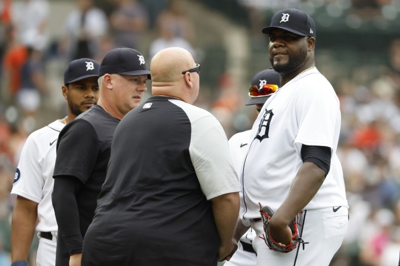 May 14, 2022; Detroit, Michigan, USA;  Detroit Tigers manager A.J. Hinch (14) and head trainer Doug Teter  check on starting pitcher Michael Pineda (38) during the second inning against the Baltimore Orioles at Comerica Park. Mandatory Credit: Rick Osentoski-USA TODAY Sports