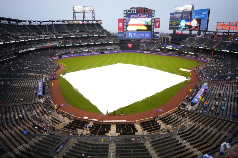 May 14, 2022; New York City, New York, USA; A tarp covers the infield at Citi Field  due to rain before the delayed start of a game between the Seattle Mariners and New York Mets. Mandatory Credit: Gregory Fisher-USA TODAY Sports