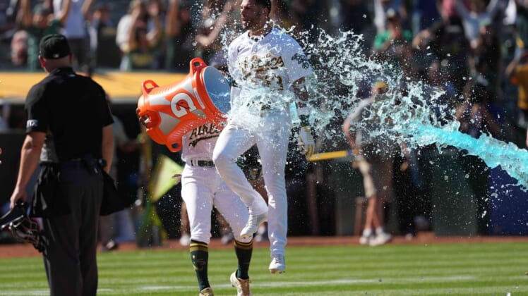 May 14, 2022; Oakland, California, USA; Oakland Athletics left fielder Luis Barrera (13) is doused with Gatorade after hitting a home run against the Los Angeles Angels in the ninth inning at RingCentral Coliseum. Mandatory Credit: Darren Yamashita-USA TODAY Sports