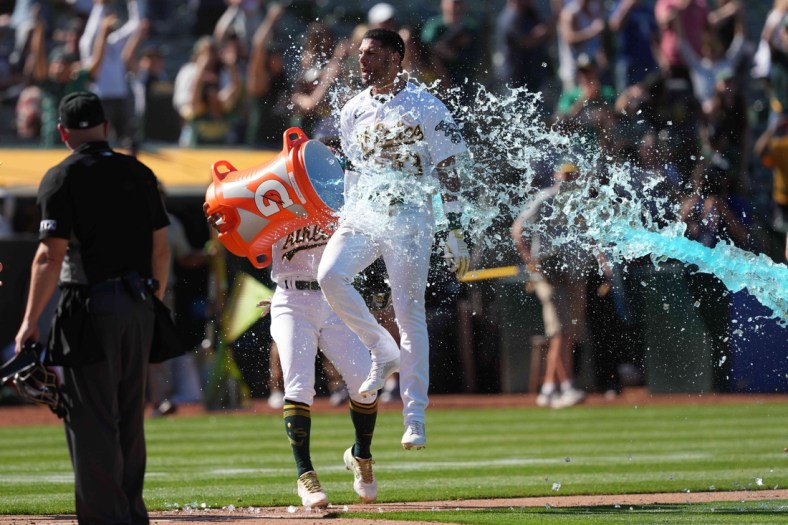 May 14, 2022; Oakland, California, USA; Oakland Athletics left fielder Luis Barrera (13) is doused with Gatorade after hitting a home run against the Los Angeles Angels in the ninth inning at RingCentral Coliseum. Mandatory Credit: Darren Yamashita-USA TODAY Sports