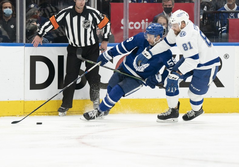 May 14, 2022; Toronto, Ontario, CAN; Toronto Maple Leafs left wing Michael Bunting (58) and Tampa Bay Lightning defenseman Erik Cernak (81) battle for the puck during the first period of game seven of the first round of the 2022 Stanley Cup Playoffs at Scotiabank Arena. Mandatory Credit: Nick Turchiaro-USA TODAY Sports