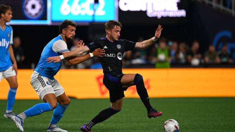 May 14, 2022; Charlotte, North Carolina, USA;  CF Montreal midfielder Djordje Mihailovic (8) with the ball as Charlotte FC defender Guzman Corujo (4) defends in the second half at Bank of America Stadium. Mandatory Credit: Bob Donnan-USA TODAY Sports