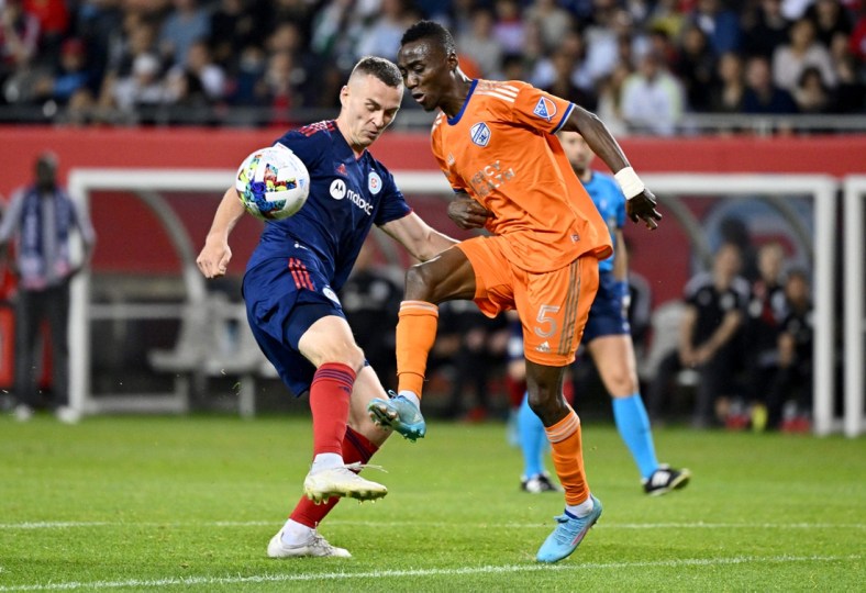 May 14, 2022; Chicago, Illinois, USA; FC Cincinnati defender Gustavo Vallecilla (5) and Chicago Fire defender Boris Sekuli   (2) battle for the ball in the second half at Soldier Field. Mandatory Credit: Jamie Sabau-USA TODAY Sports