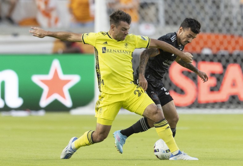 May 14, 2022; Houston, Texas, USA; Nashville SC midfielder Brian Anunga (27) fights Houston Dynamo defender Zeca (37) for the ball in the first half at PNC Stadium. Mandatory Credit: Thomas Shea-USA TODAY Sports