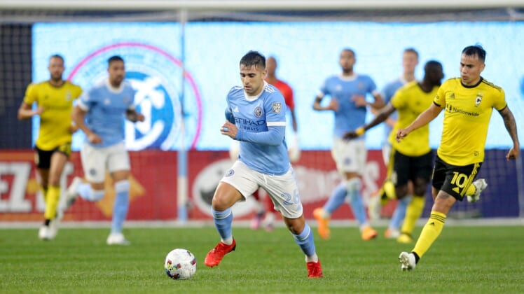 May 14, 2022; New York, New York, USA; New York City FC midfielder Nicolas Acevedo (26) brings the ball up the pitch against Columbus Crew midfielder Lucas Zelarrayan (10) during the first half at Yankee Stadium. Mandatory Credit: Brad Penner-USA TODAY Sports