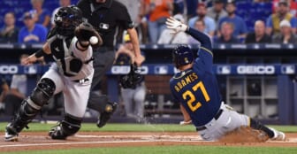 May 15, 2022; Miami, Florida, USA; Milwaukee Brewers Willy Adames (27) slides ahead of the throw received by  Miami Marlins catcher Payton Henry (59) during the first inning at loanDepot Park. Mandatory Credit: Jim Rassol-USA TODAY Sports