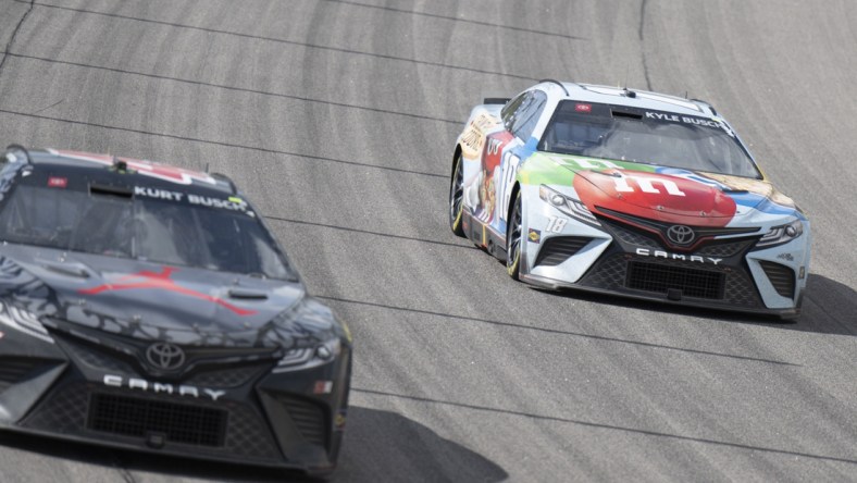 May 15, 2022; Kansas City, Kansas, USA; NASCAR Cup Series driver Kurt Busch (45) and NASCAR Cup Series driver Kyle Busch (18) race during the AdventHealth 400 at Kansas Speedway. Mandatory Credit: Amy Kontras-USA TODAY Sports