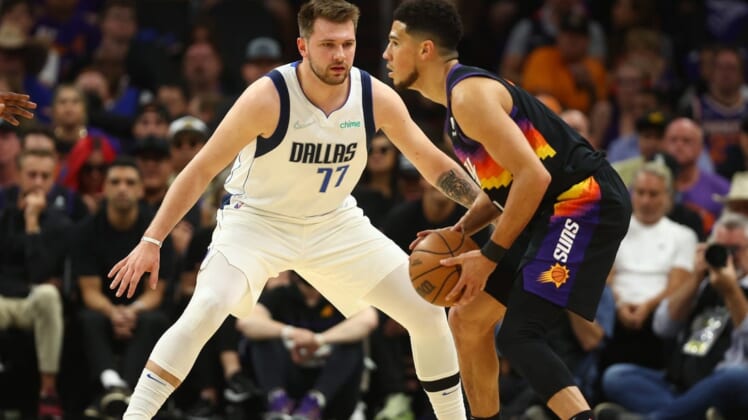 May 15, 2022; Phoenix, Arizona, USA; Dallas Mavericks guard Luka Doncic (77) against Phoenix Suns guard Devin Booker (1) in game seven of the second round for the 2022 NBA playoffs at Footprint Center. Mandatory Credit: Mark J. Rebilas-USA TODAY Sports