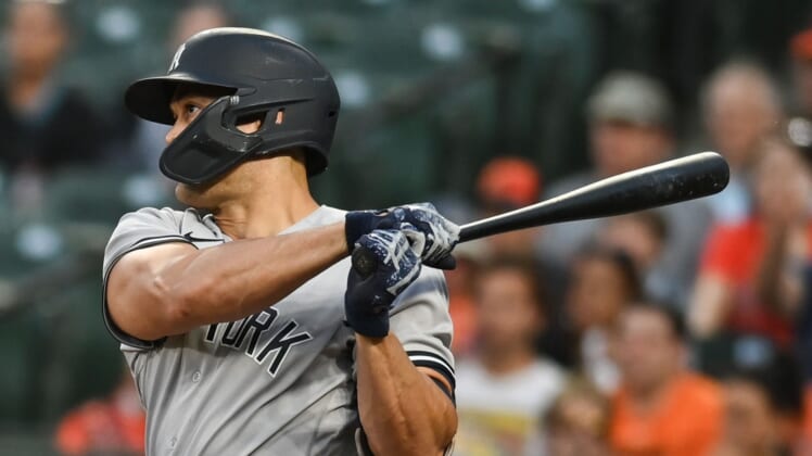 May 16, 2022; Baltimore, Maryland, USA;  New York Yankees designated hitter Giancarlo Stanton (27) swings through a third inning rbi double against the Baltimore Orioles at Oriole Park at Camden Yards. Mandatory Credit: Tommy Gilligan-USA TODAY Sports