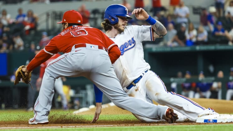 May 16, 2022; Arlington, Texas, USA;  Texas Rangers catcher Jonah Heim (28) slides safely into third base ahead of the tag by Los Angeles Angels third baseman Anthony Rendon (6) during the first inning at Globe Life Field. Mandatory Credit: Kevin Jairaj-USA TODAY Sports