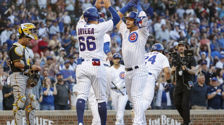 May 16, 2022; Chicago, Illinois, USA; Chicago Cubs catcher Willson Contreras (40) celebrates with left fielder Rafael Ortega (66) as he crosses home plate after hitting a grand slam off of Pittsburgh Pirates relief pitcher Bryse Wilson during the first inning at Wrigley Field. Mandatory Credit: Kamil Krzaczynski-USA TODAY Sports