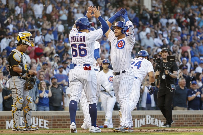 May 16, 2022; Chicago, Illinois, USA; Chicago Cubs catcher Willson Contreras (40) celebrates with left fielder Rafael Ortega (66) as he crosses home plate after hitting a grand slam off of Pittsburgh Pirates relief pitcher Bryse Wilson during the first inning at Wrigley Field. Mandatory Credit: Kamil Krzaczynski-USA TODAY Sports