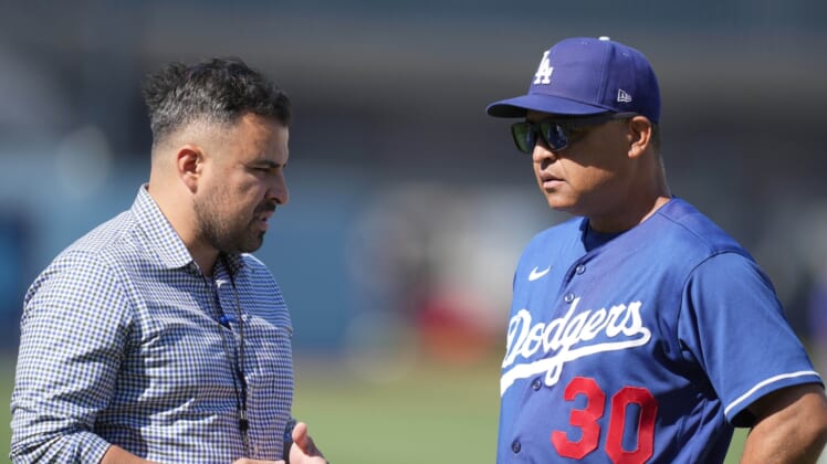 May 16, 2022; Los Angeles, California, USA; Los Angeles Dodgers manager Dave Roberts (right talks with public relations manager Juan Dorado before the game against the Arizona Diamondbacks at Dodger Stadium. Mandatory Credit: Kirby Lee-USA TODAY Sports