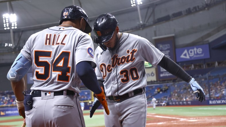 May 16, 2022; St. Petersburg, Florida, USA; Detroit Tigers shortstop Harold Castro (30) is congratulated by Detroit Tigers center fielder Derek Hill (54) as he scores run during the ninth inning against the Tampa Bay Rays at Tropicana Field. Mandatory Credit: Kim Klement-USA TODAY Sports