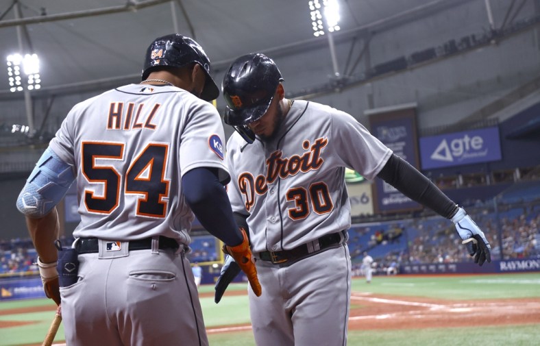 May 16, 2022; St. Petersburg, Florida, USA; Detroit Tigers shortstop Harold Castro (30) is congratulated by Detroit Tigers center fielder Derek Hill (54) as he scores run during the ninth inning against the Tampa Bay Rays at Tropicana Field. Mandatory Credit: Kim Klement-USA TODAY Sports