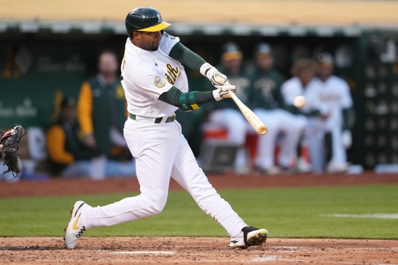 May 16, 2022; Oakland, California, USA; Oakland Athletics shortstop Elvis Andrus (17) hits an RBI double against the Minnesota Twins during the fourth inning at RingCentral Coliseum. Mandatory Credit: Darren Yamashita-USA TODAY Sports