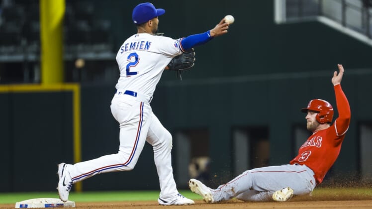 May 16, 2022; Arlington, Texas, USA;  Texas Rangers second baseman Marcus Semien (2) completes a double play over Los Angeles Angels right fielder Taylor Ward (3) during the seventh inning at Globe Life Field. Mandatory Credit: Kevin Jairaj-USA TODAY Sports
